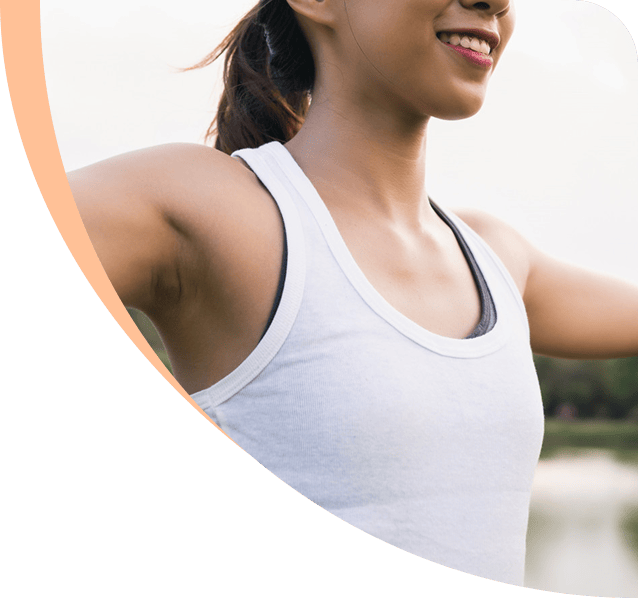 Woman stretching outdoors, representing wellness and urology care at Bergen Urology.